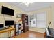 Home office with wood desk, window, and musical instruments at 1002 Palmer Dr., Calabash, NC 28467