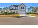 Two-story house with gray siding, a two-car garage, and landscaping at 217 Astoria Park Loop, Conway, SC 29526