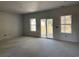 Empty living room with sliding glass doors and windows, awaiting finishing touches at 240 Palmetto Sand Loop, Conway, SC 29527