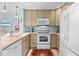 Modern kitchen with light cabinets and white appliances at 310 Marsh Pl. # 312, Murrells Inlet, SC 29576