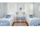 Bedroom with twin beds, light blue walls, and hardwood floors at 332 N Congdon St., Georgetown, SC 29440