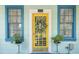 Bright yellow front door with a wreath flanked by blue windows at 332 N Congdon St., Georgetown, SC 29440