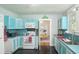 Bright teal kitchen with white appliances and view to dining area at 332 N Congdon St., Georgetown, SC 29440