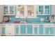 Small kitchen with teal cabinets, white appliances, and wavy countertop at 332 N Congdon St., Georgetown, SC 29440