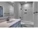 Bathroom with gray vanity, marble-look tile shower, and white bathtub at 335 Happy Valley Dr., Myrtle Beach, SC 29588