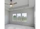 Main bedroom with ceiling fan, grey carpet, and multiple windows at 335 Happy Valley Dr., Myrtle Beach, SC 29588