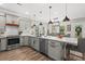 L shaped kitchen island with white quartz countertops and gray cabinets at 355 Oak Ave., Murrells Inlet, SC 29576