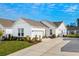 White house with gray roof, landscaping, and a two-car garage at 4036-D Taranto Loop # 5404-D, Myrtle Beach, SC 29579