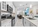 Open concept kitchen with island, stainless steel appliances, and view to living area at 4036-D Taranto Loop # 5404-D, Myrtle Beach, SC 29579