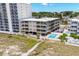 Aerial view showing condo building, pool, and nearby beach at 4305 S Ocean Blvd. # 302, North Myrtle Beach, SC 29582