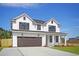 Two-story farmhouse-style home with a brown garage door and landscaped lawn at 5118 Middleton View Dr., Myrtle Beach, SC 29579