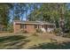 Brick ranch house with a white porch, steps, and landscaped lawn at 538 Oak Circle Dr., Myrtle Beach, SC 29588