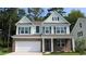 Two-story home with brick and siding, a white garage door and landscaping at 567 Haven View Way, Murrells Inlet, SC 29576