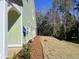 Landscaped side yard with pine straw and a view of the woods at 604 Mccown Dr., Conway, SC 29526