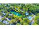 An aerial view of the property in relation to the community pool and pond at 77 Salt Marsh Circle # 18E, Pawleys Island, SC 29585