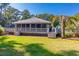 Backyard with deck, palm tree, and lush green lawn at 77 Salt Marsh Circle # 18E, Pawleys Island, SC 29585