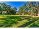 Open green space with mature trees in a community at 77 Salt Marsh Circle # 18E, Pawleys Island, SC 29585