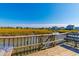 Wooden dock with bench, offering scenic marsh views at 77 Salt Marsh Circle # 18E, Pawleys Island, SC 29585