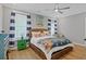 Guest bedroom with coastal decor, ceiling fan and hardwood floors at 8050 Yamassee St. # A, Myrtle Beach, SC 29572