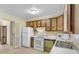 Kitchen with wood cabinets, white appliances, and tile floor at 102 Dorman Circle, Myrtle Beach, SC 29577