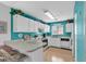 Efficient kitchen with white cabinets and teal walls at 1107 N Waccamaw Dr., Garden City Beach, SC 29576