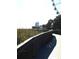 Boardwalk path with wooden railings, overlooking grassy dunes and a Ferris wheel in the distance at 1200 N Ocean Blvd. # 307, Myrtle Beach, SC 29577