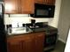 Small kitchen with granite countertop, black appliances at 1200 N Ocean Blvd. # 307, Myrtle Beach, SC 29577