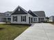 Craftsman style home with gray siding, dark roof, and a 2-car garage at 1228 Needle Grass Loop, Myrtle Beach, SC 29579