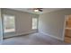 Bright bedroom featuring carpet flooring and two large windows at 1521 Hawthorn Dr., Pawleys Island, SC 29585