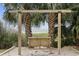 Wooden swing bench nestled between palm trees, overlooking the ocean at 2000 N Ocean Blvd. # 315, Myrtle Beach, SC 29577