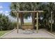 Wooden swing bench nestled between palm trees facing the ocean at 2000 N Ocean Blvd. # 315, Myrtle Beach, SC 29577