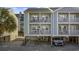 Two-story home with light green and gray siding, balconies, and parking underneath at 209 North Hillside Dr. # 201, North Myrtle Beach, SC 29582
