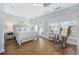 Main bedroom with gray wood-like platform bed, rocking chair, and hardwood floors at 209 North Hillside Dr. # 201, North Myrtle Beach, SC 29582