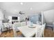 Open concept dining area with white table and chairs, hardwood floors, and kitchen views at 209 North Hillside Dr. # 201, North Myrtle Beach, SC 29582