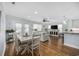 Bright dining area with white table and chairs, hardwood floors, and access to living room at 209 North Hillside Dr. # 201, North Myrtle Beach, SC 29582