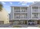 Two-story home with light green and gray siding, balconies, and parking underneath at 209 North Hillside Dr. # 201, North Myrtle Beach, SC 29582