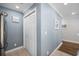 Hallway with light blue walls, wood floors and linen closet at 209 North Hillside Dr. # 201, North Myrtle Beach, SC 29582