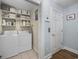Convenient laundry room with washer, dryer, and shelving at 209 North Hillside Dr. # 201, North Myrtle Beach, SC 29582