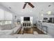 Open living room with light gray couch, TV, and kitchen bar at 209 North Hillside Dr. # 201, North Myrtle Beach, SC 29582