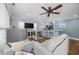 Living room features hardwood floors, comfy sofas, and a large TV at 209 North Hillside Dr. # 201, North Myrtle Beach, SC 29582