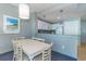 Bright dining area with white table and chairs, kitchen view at 300 N Ocean Blvd. # 1628, North Myrtle Beach, SC 29582