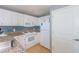 White kitchen cabinets, granite counters, and blue tile backsplash at 300 N Ocean Blvd. # 1628, North Myrtle Beach, SC 29582