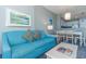 Teal sofa and coffee table in living room with view to dining area at 300 N Ocean Blvd. # 1628, North Myrtle Beach, SC 29582