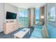 Living room with ocean view, teal sofa and balcony access at 300 N Ocean Blvd. # 1628, North Myrtle Beach, SC 29582