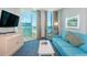 Living room with ocean view and teal sofa at 300 N Ocean Blvd. # 1628, North Myrtle Beach, SC 29582