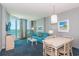 Living room with ocean view, teal sofa, and dining area at 300 N Ocean Blvd. # 1628, North Myrtle Beach, SC 29582