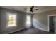 Bright bedroom with two large windows, ceiling fan, and neutral gray walls at 3057 Moss Bridge Ln., Myrtle Beach, SC 29579