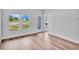 Bedroom with hardwood floors, two windows, and access to patio at 310 Sandridgebury Dr. # 40, Little River, SC 29566