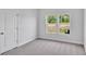 Bedroom with carpet floors, two windows, and a closet at 310 Sandridgebury Dr. # 40, Little River, SC 29566
