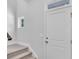 Front entry with white door, carpet stairs, and small window at 310 Sandridgebury Dr. # 40, Little River, SC 29566